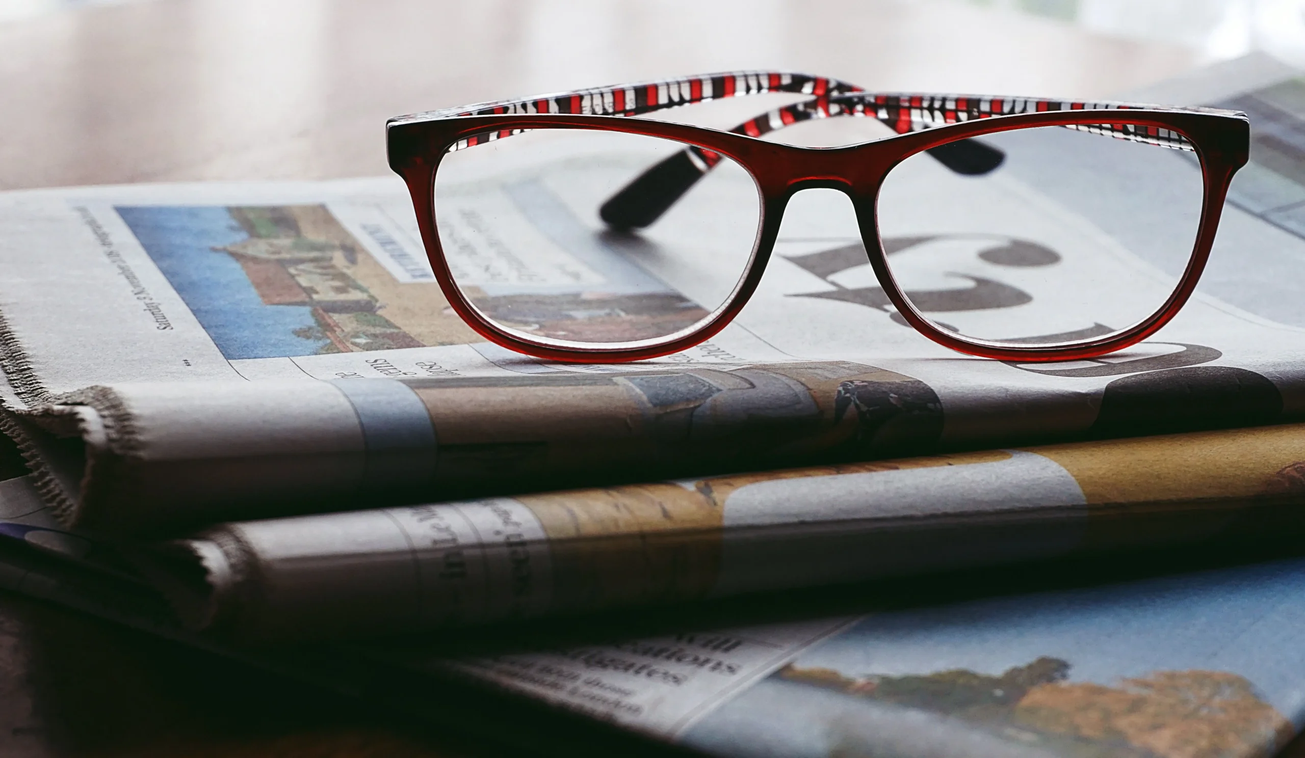 Glasses on the bundle of newspapers.