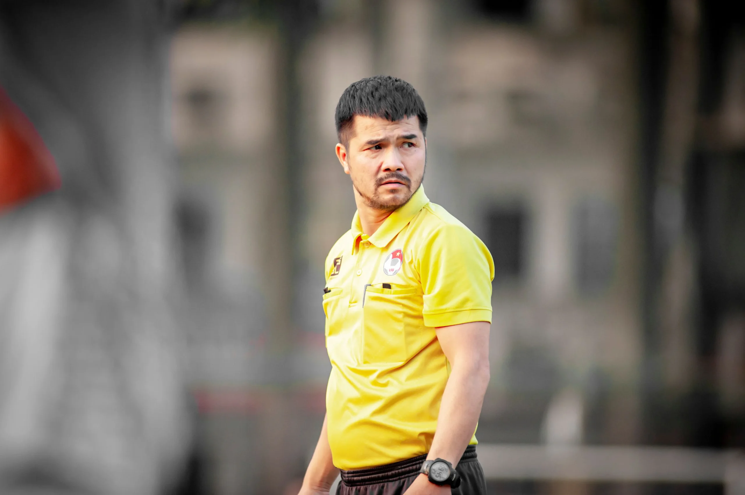 A coach looking at the ground.