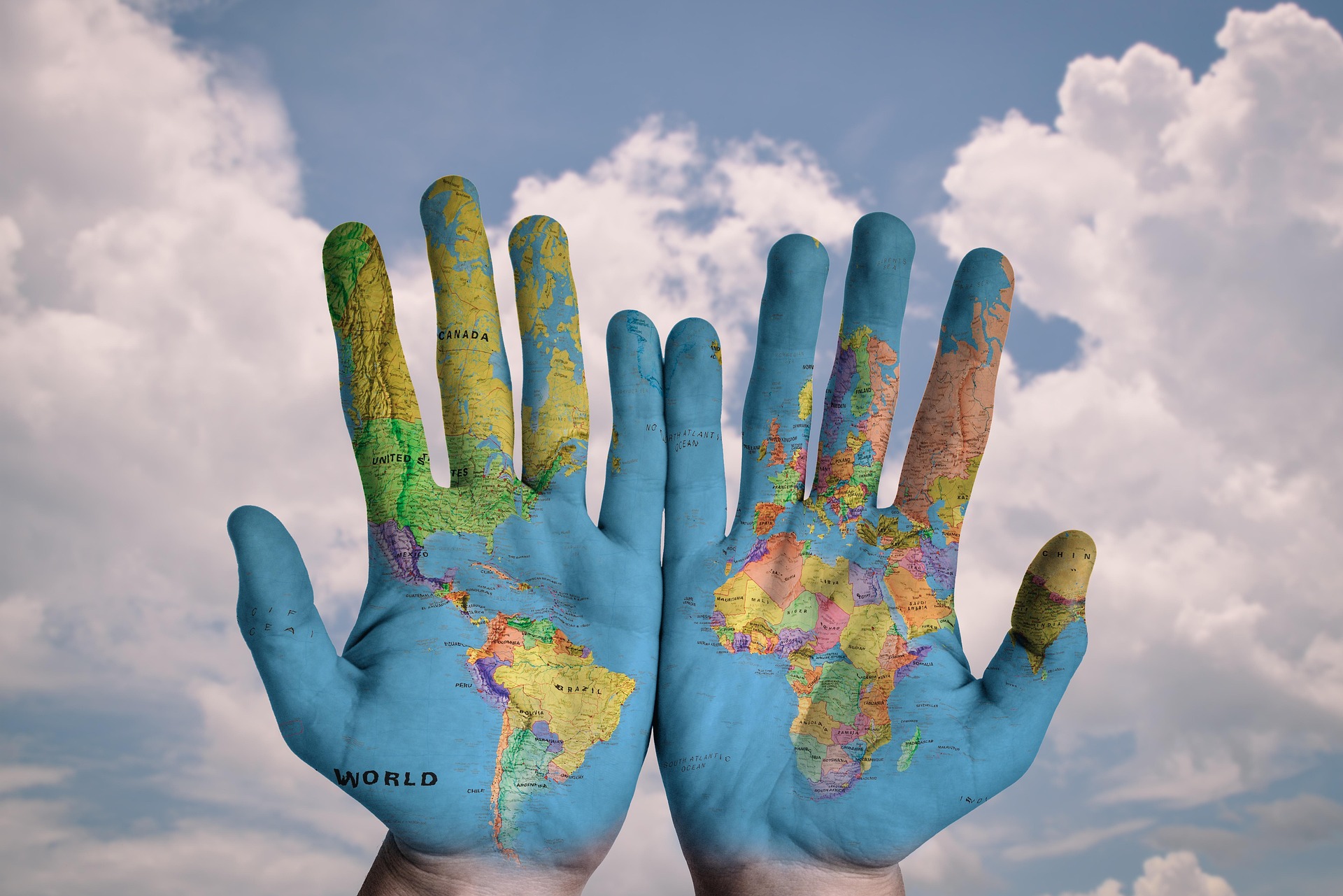 Hands coloured with the world map