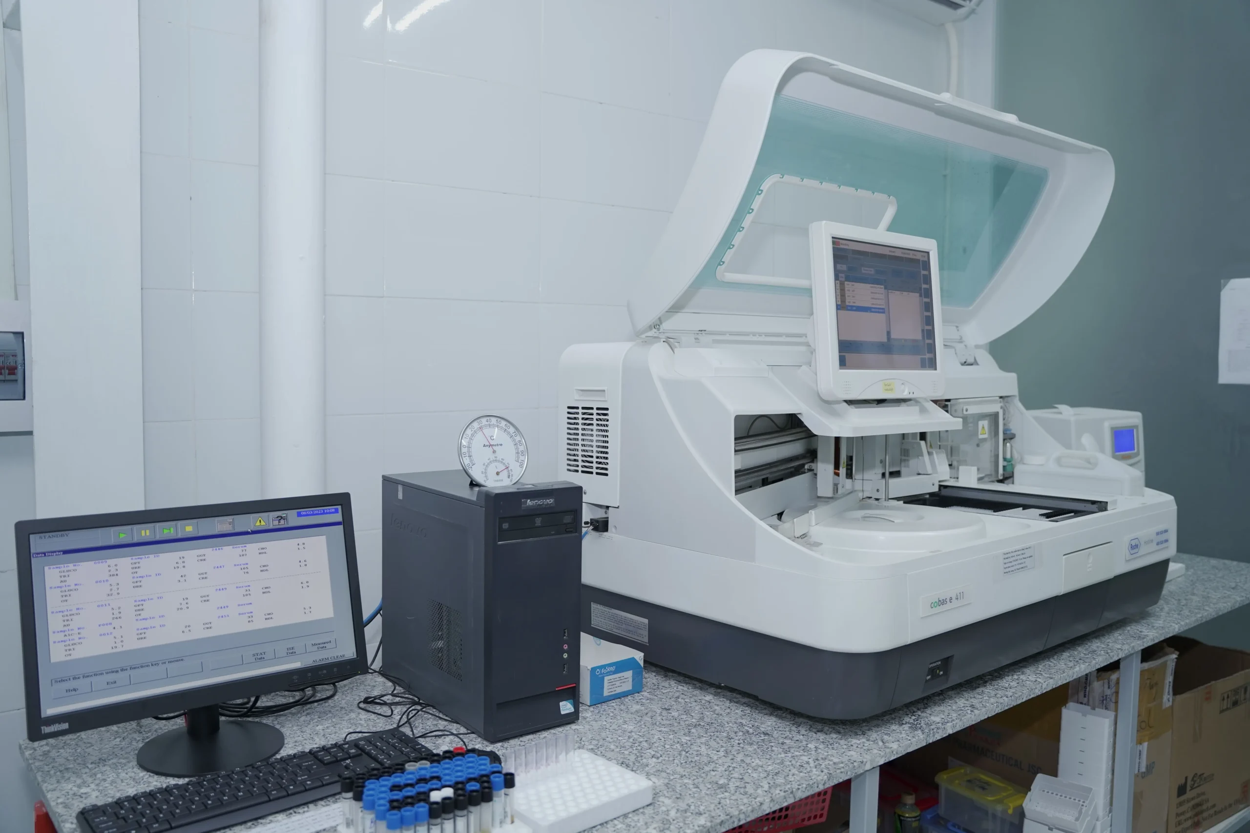 A computer and some lab equipments placed inside the lab.