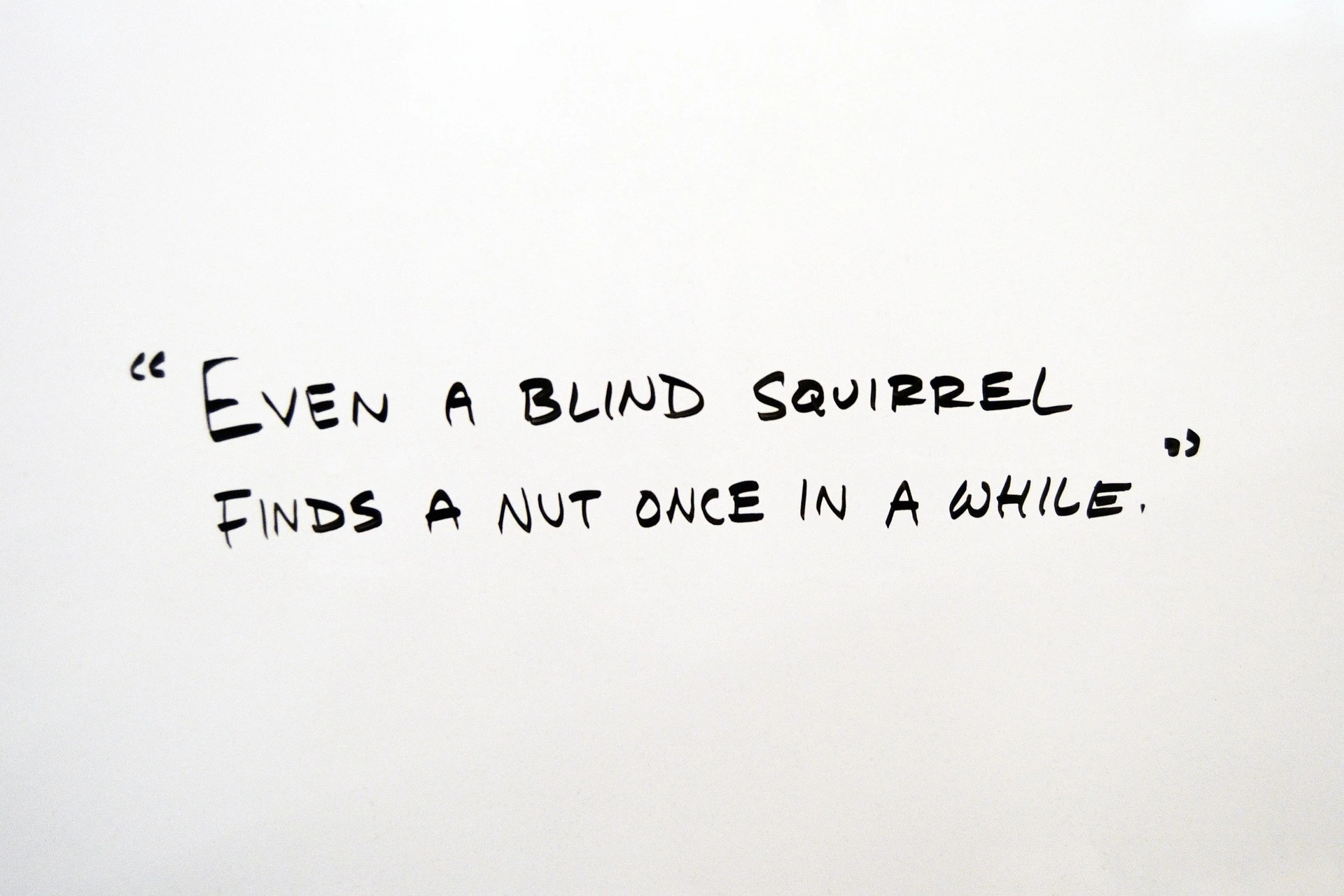 An idiom quote is written on the creamy background.