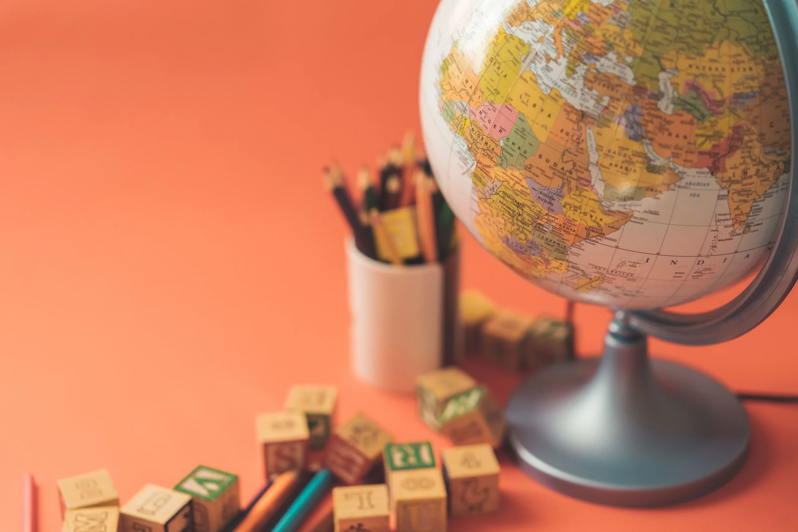 A world globe with an orange background