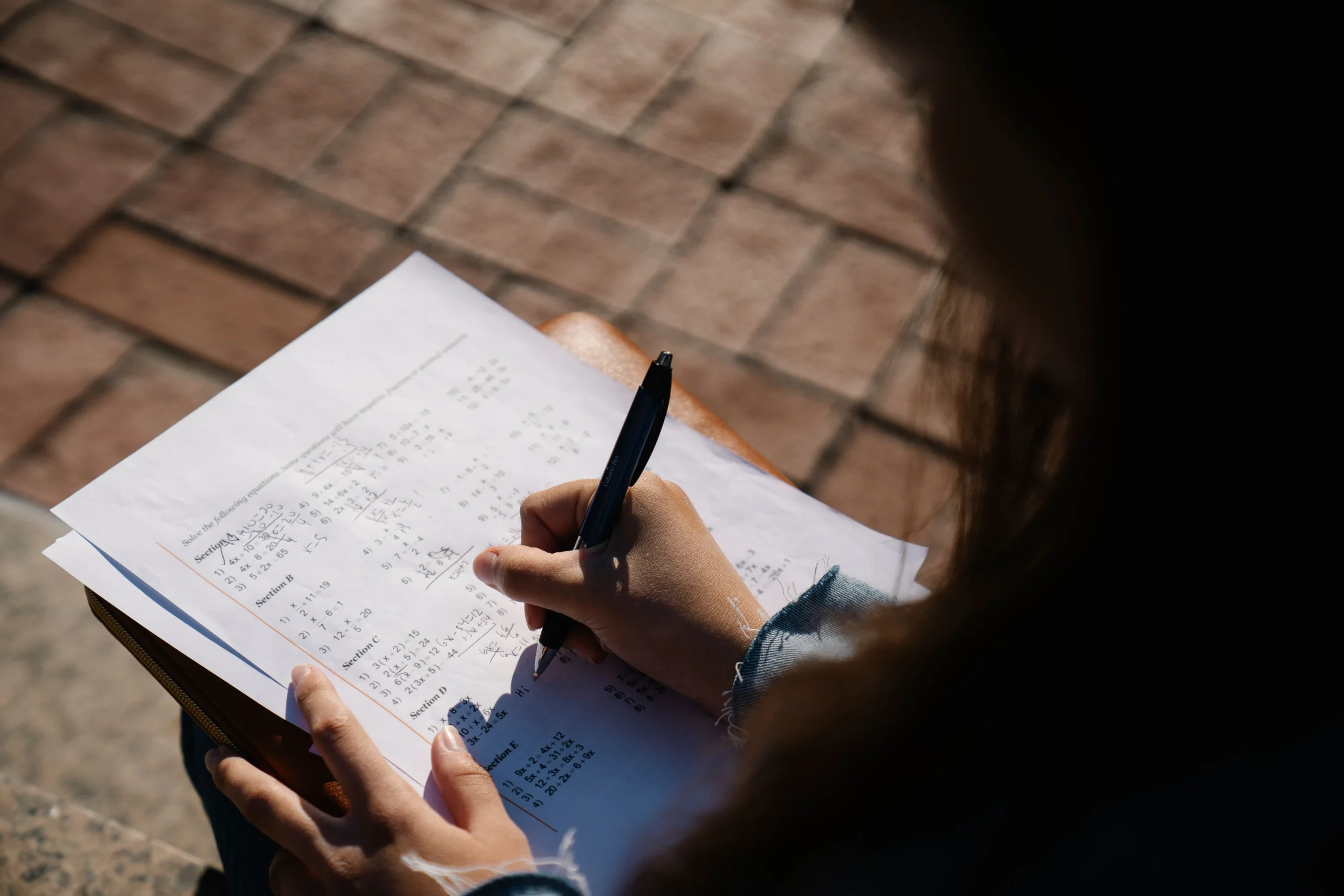 A girl is looking at the paper.