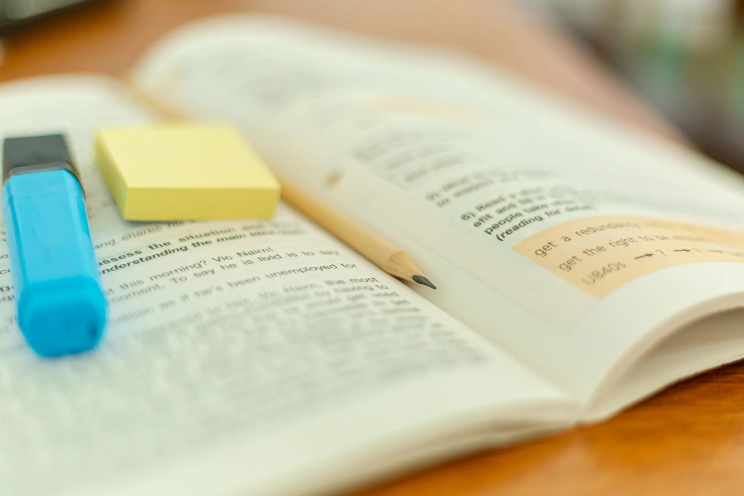 The pen and marker are placed on the opened book.
