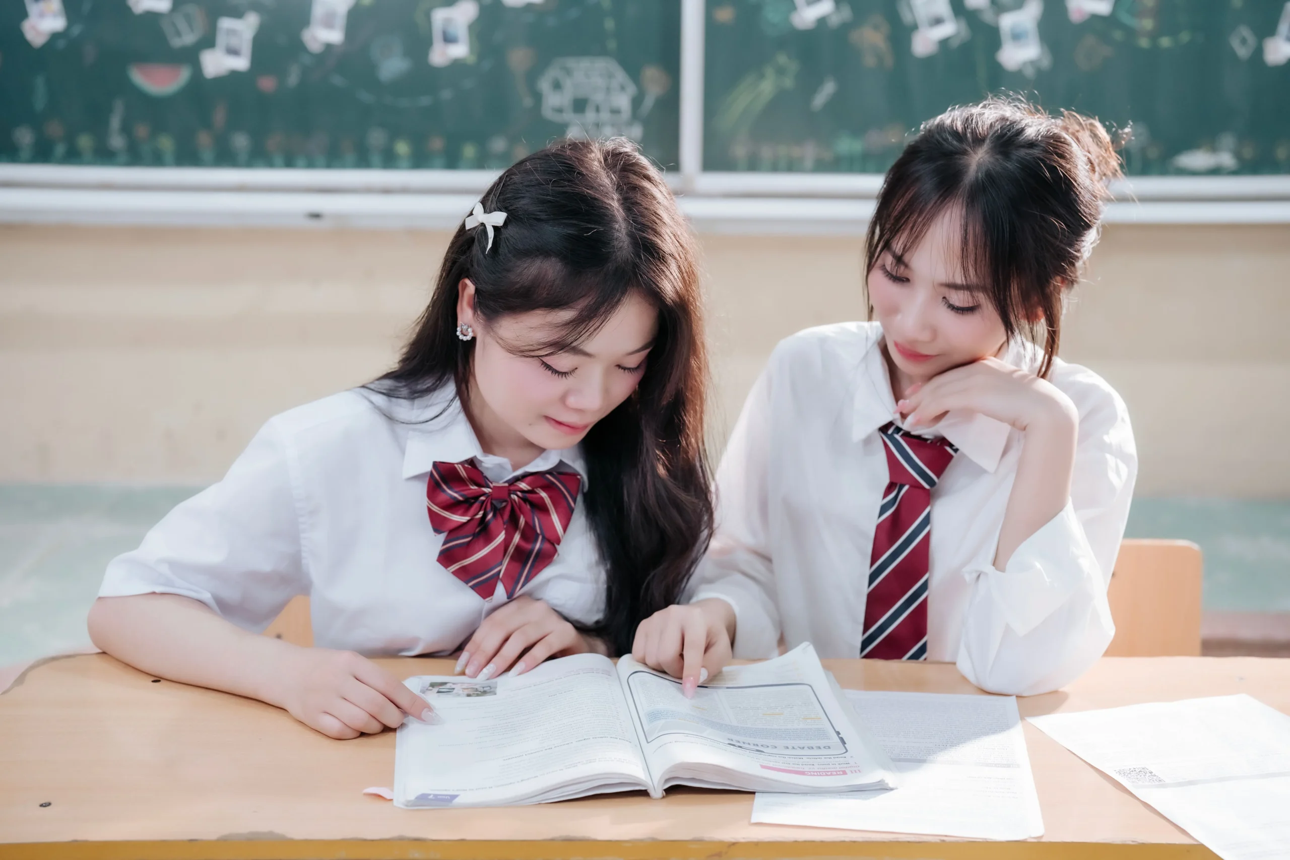 Two girls are studying together
