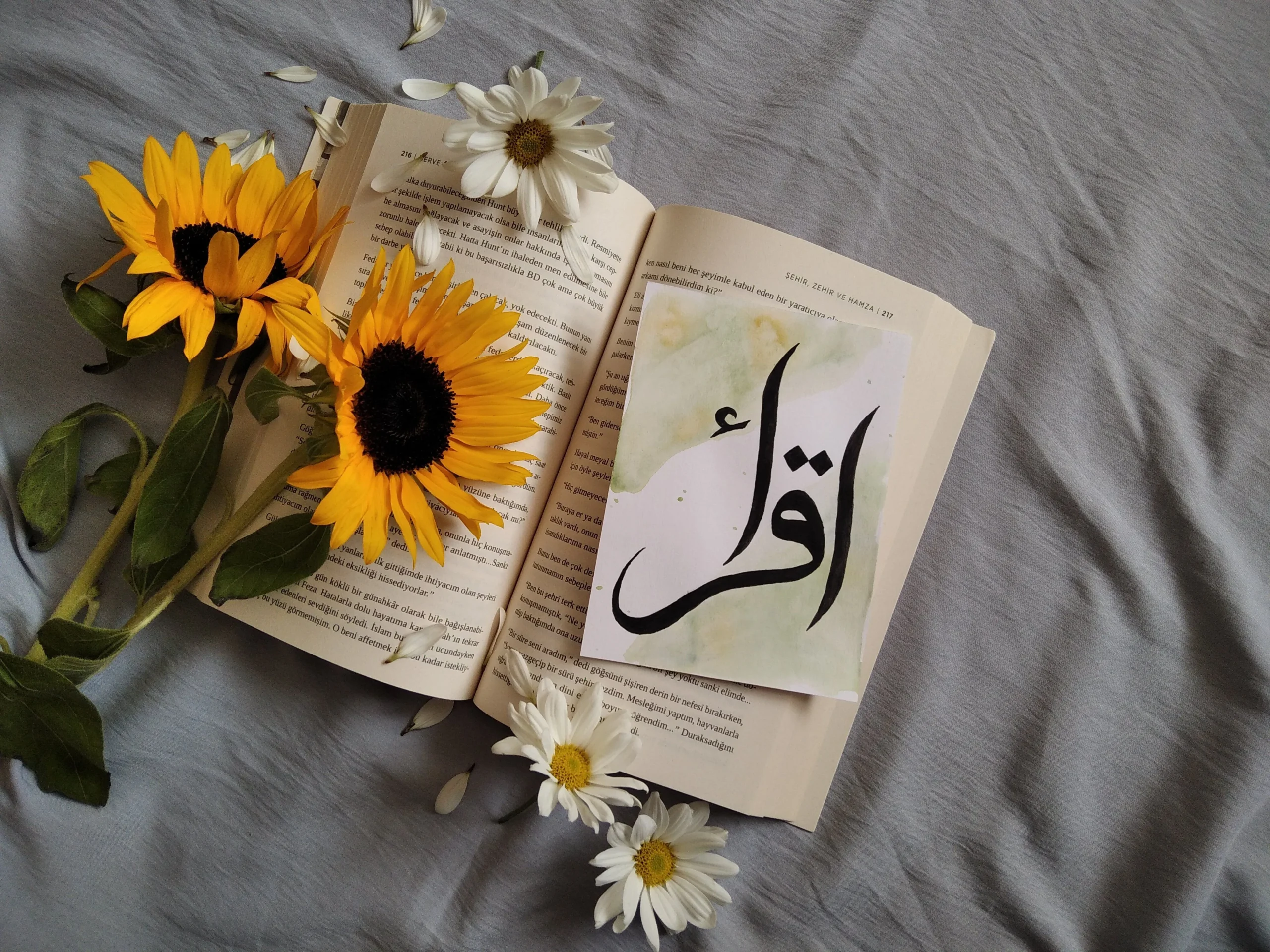 An Urdu word is written on the book page.