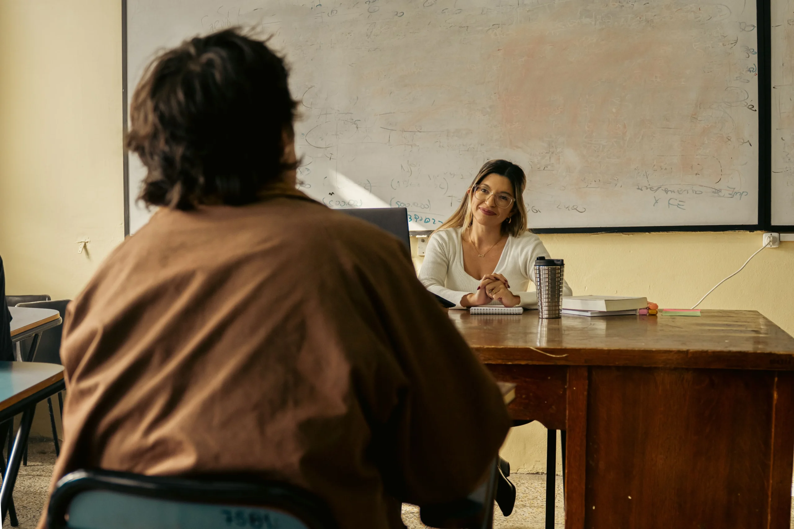 A teacher and a student discussing with each other.