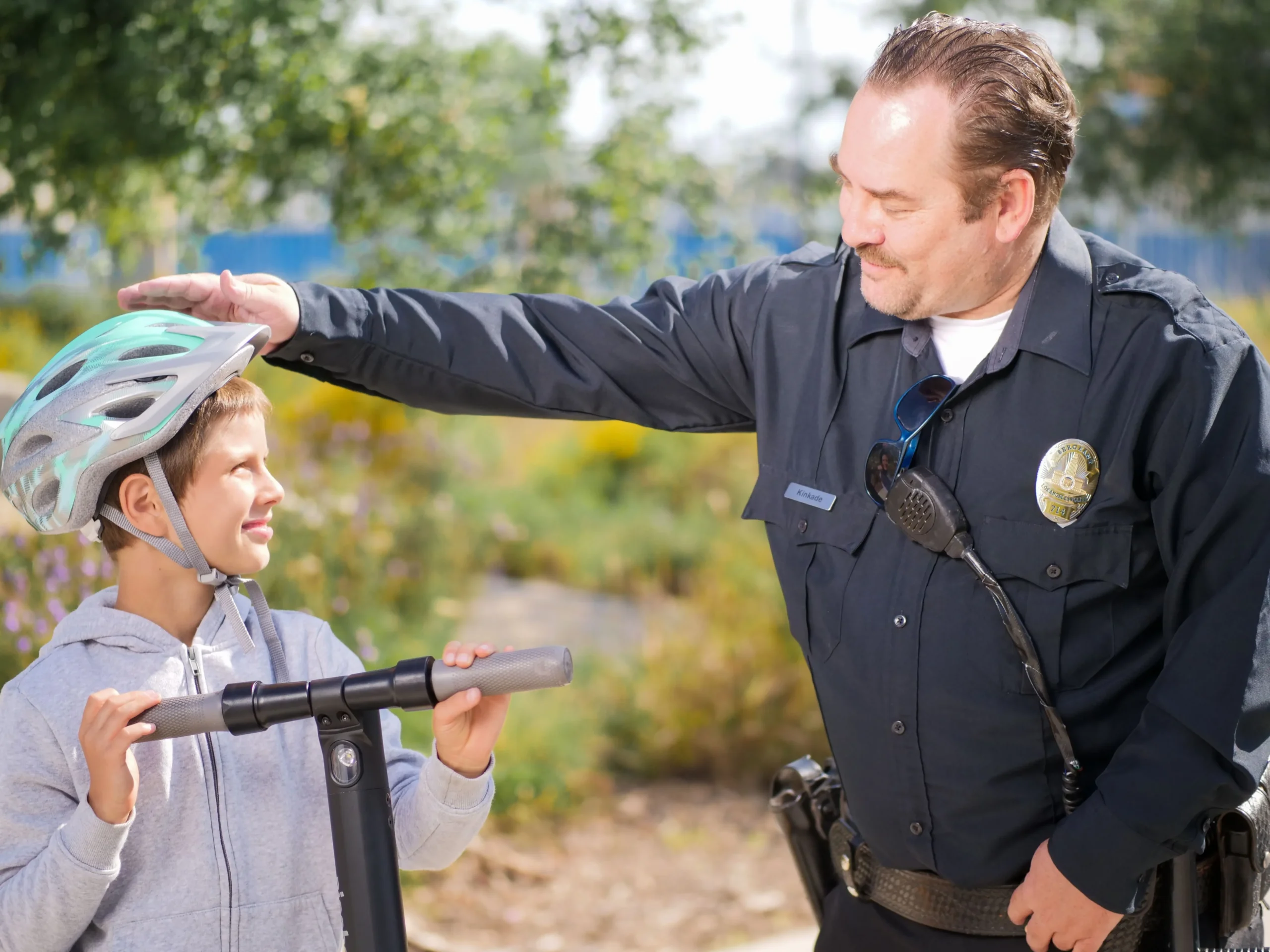 An inspector is smiling at the boy.