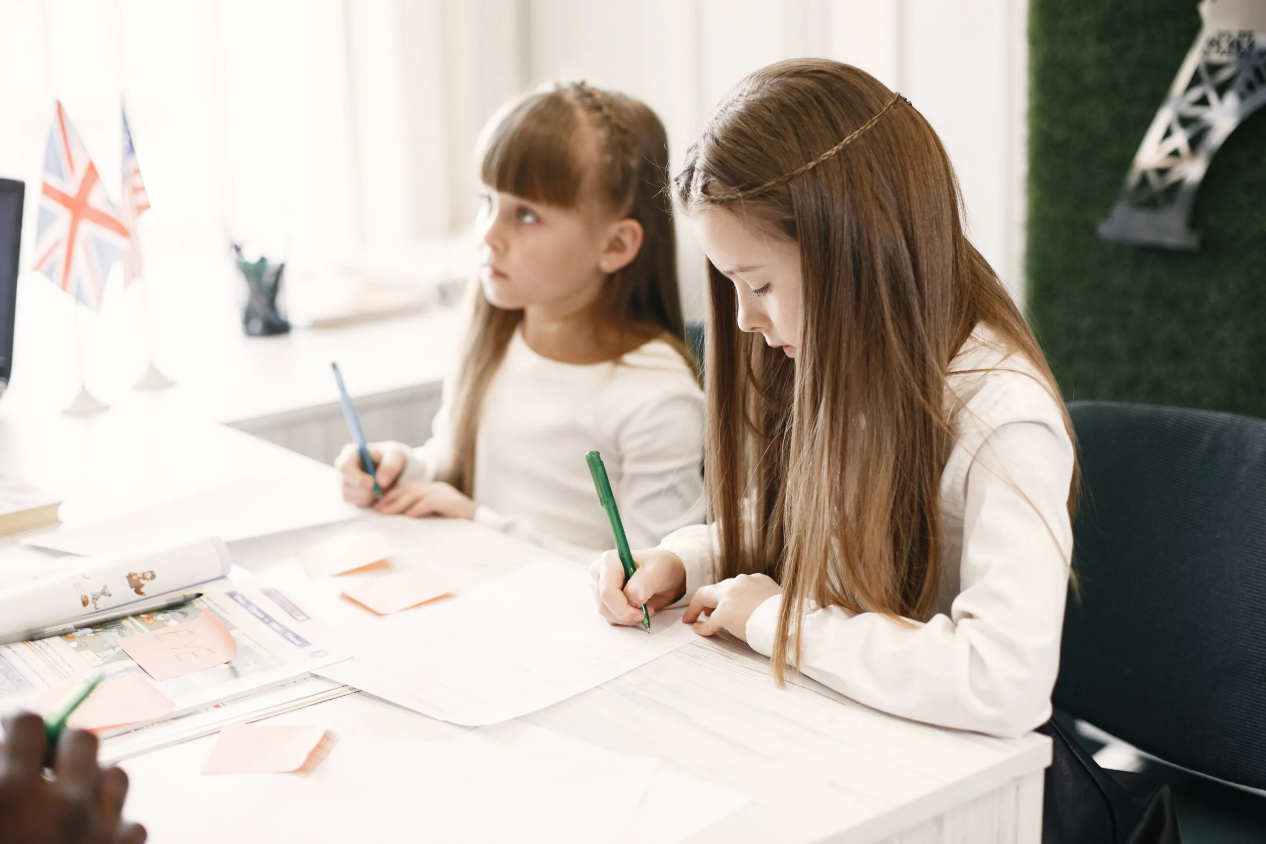 Little girls are writing their homework.