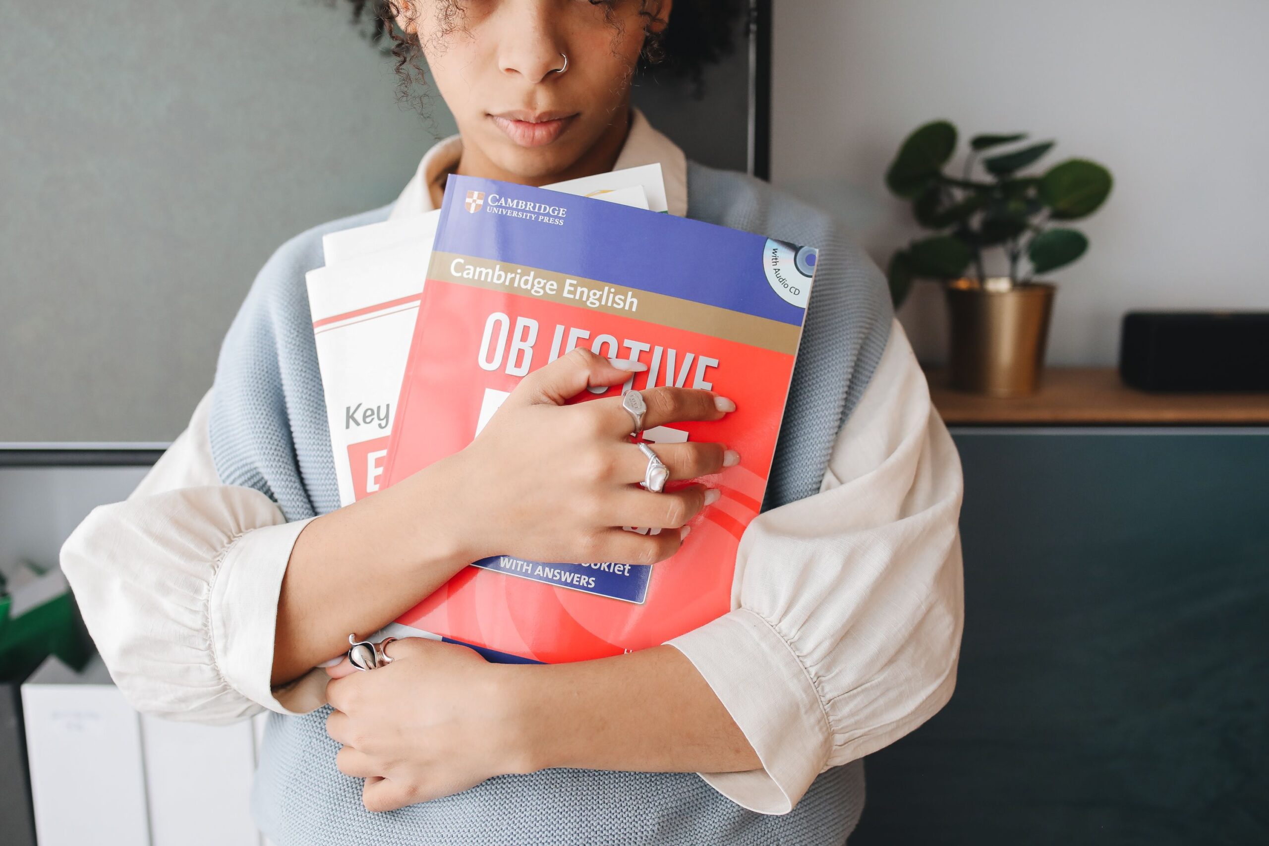 A girl hugging books.