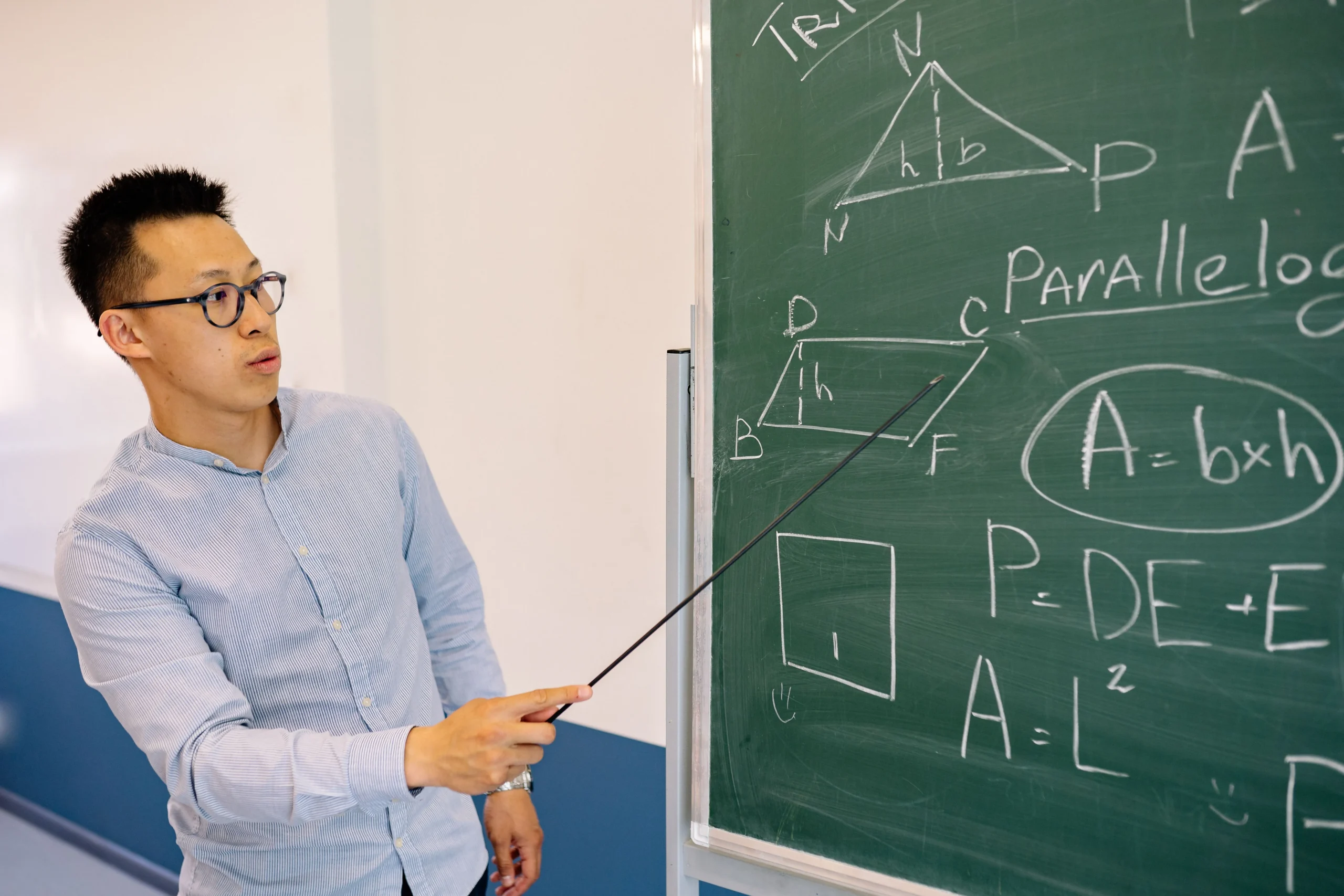 A mathematics teacher on the board.