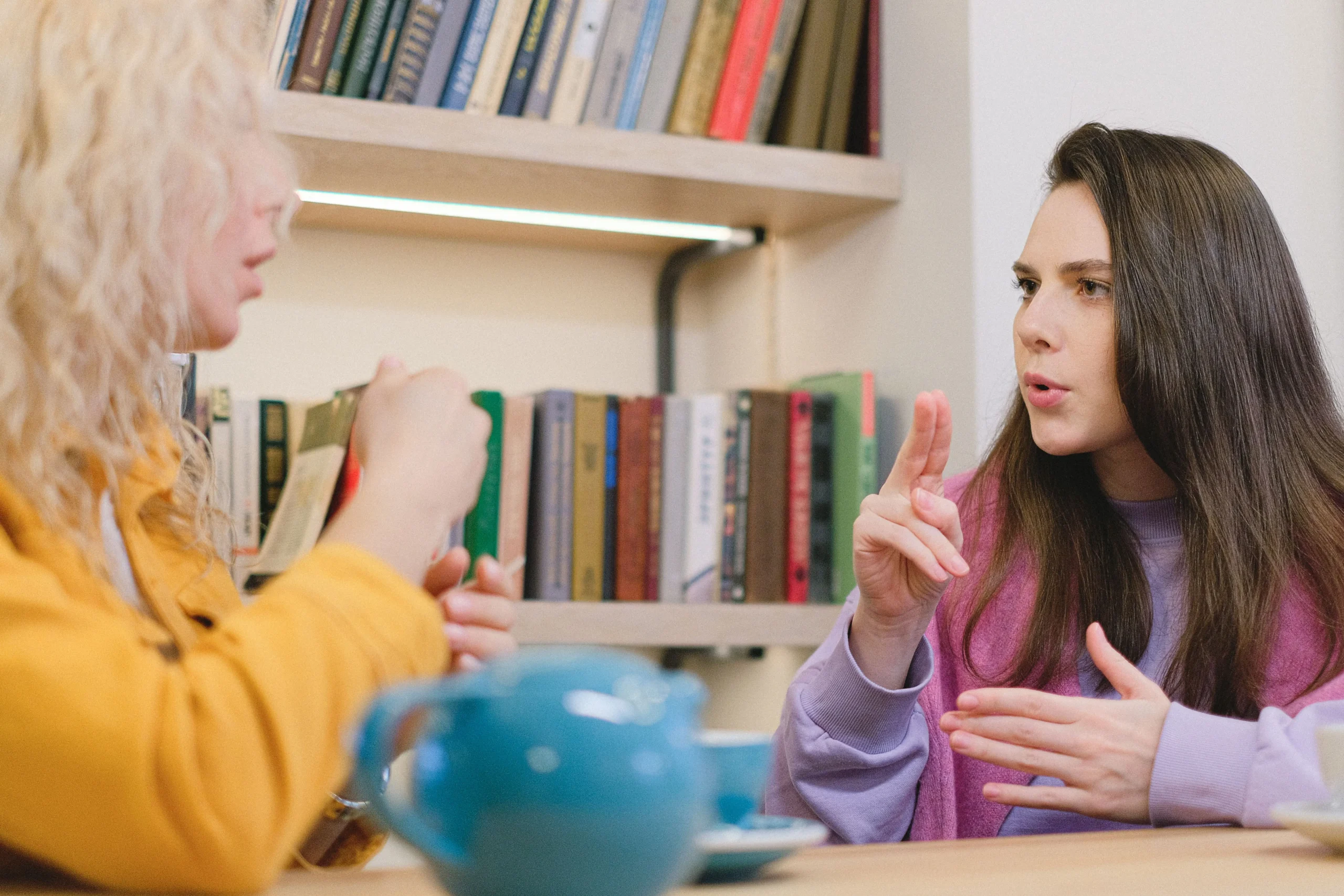 Two girls are talking to each other.