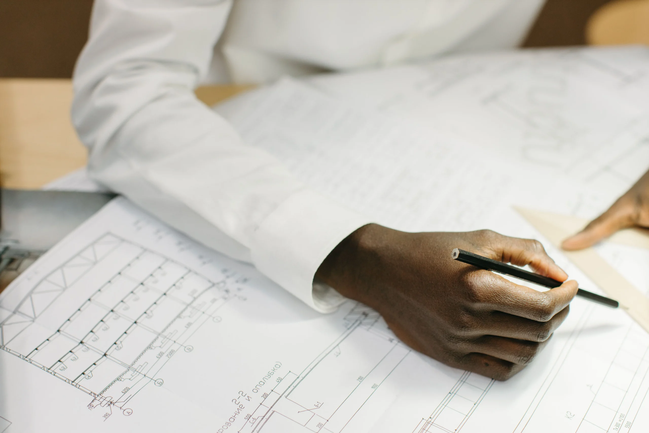 A man is doing engineering work on the paper.