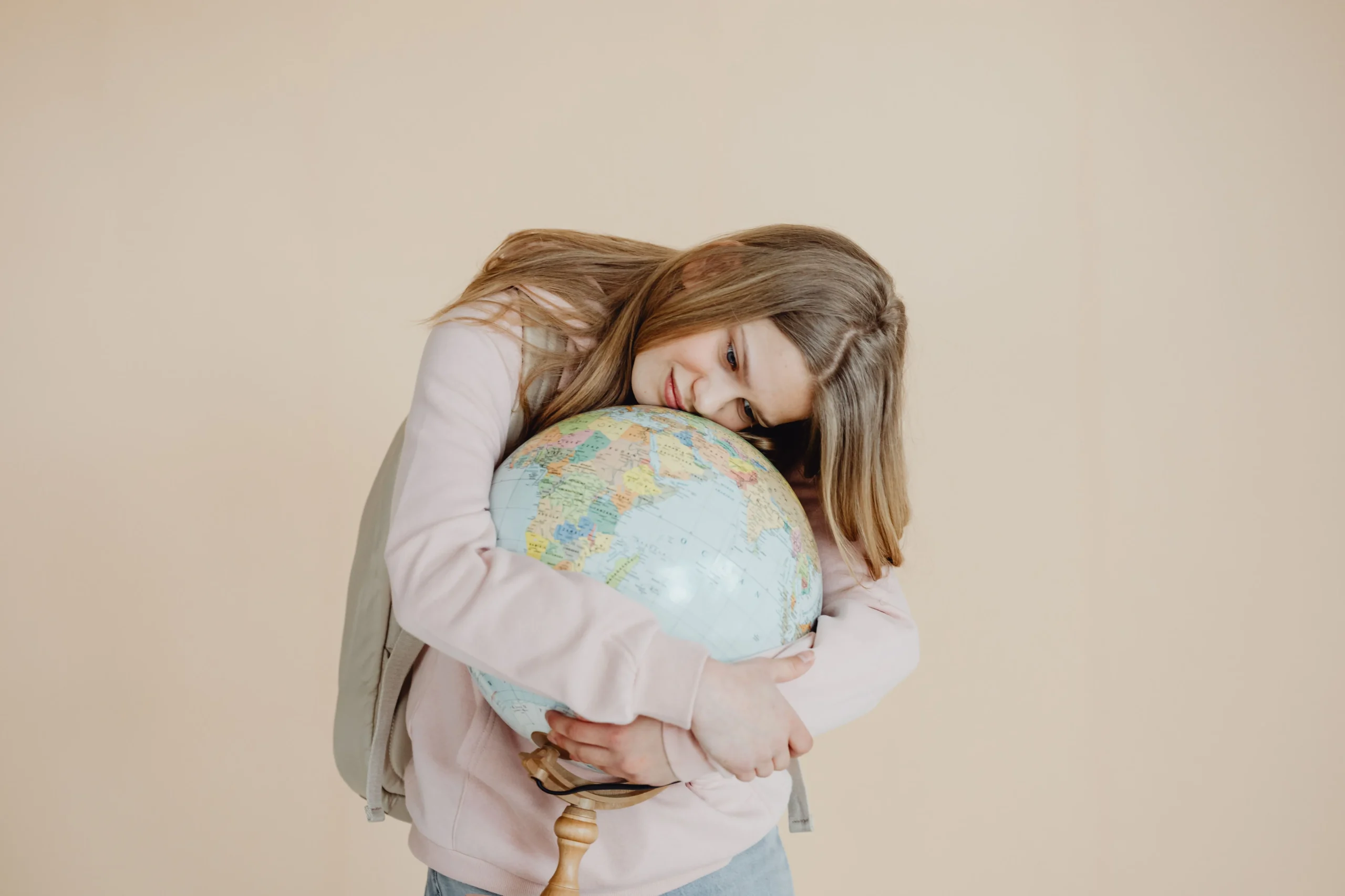 A girl hugging the globe.