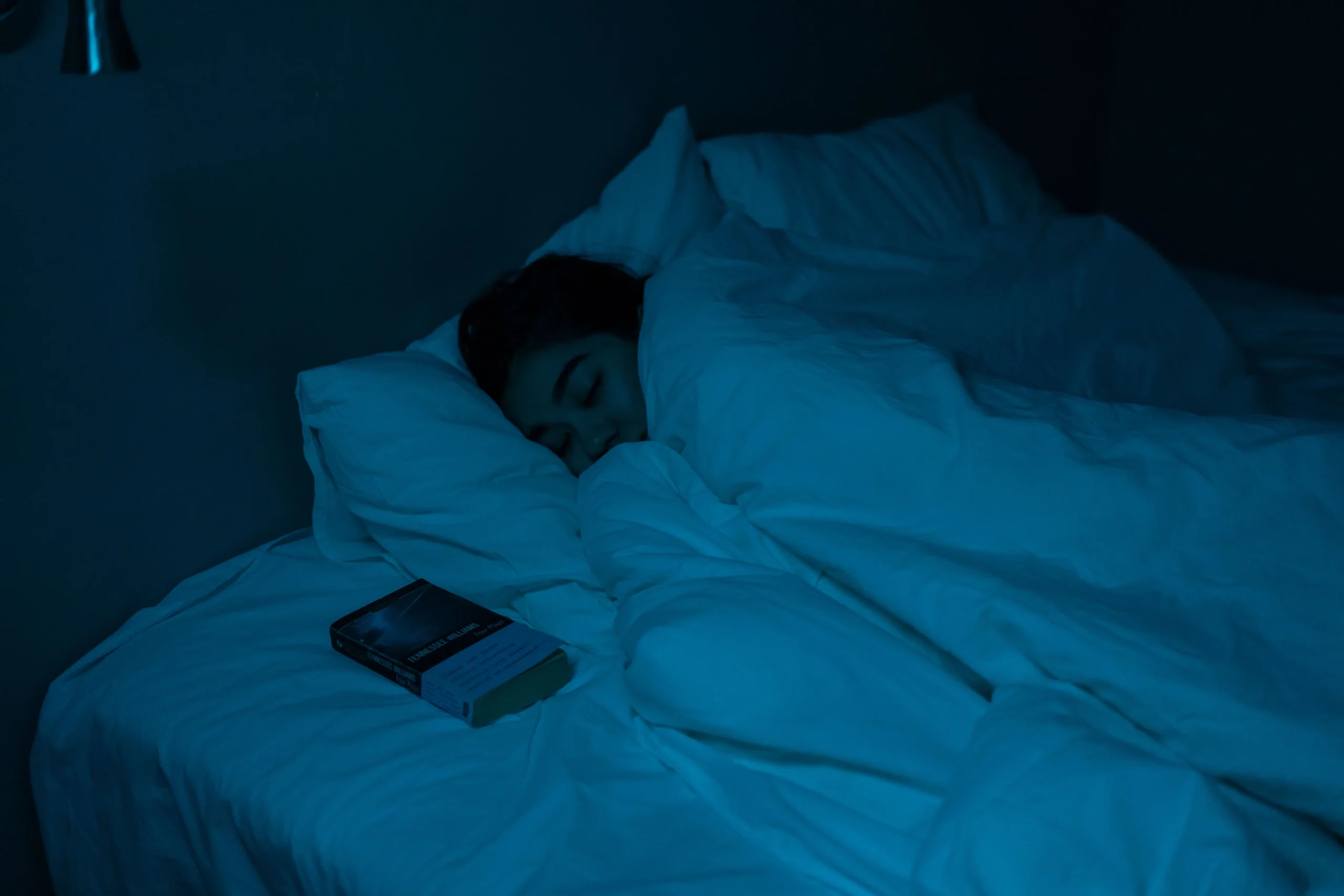 A girl is sleeping on her bed.