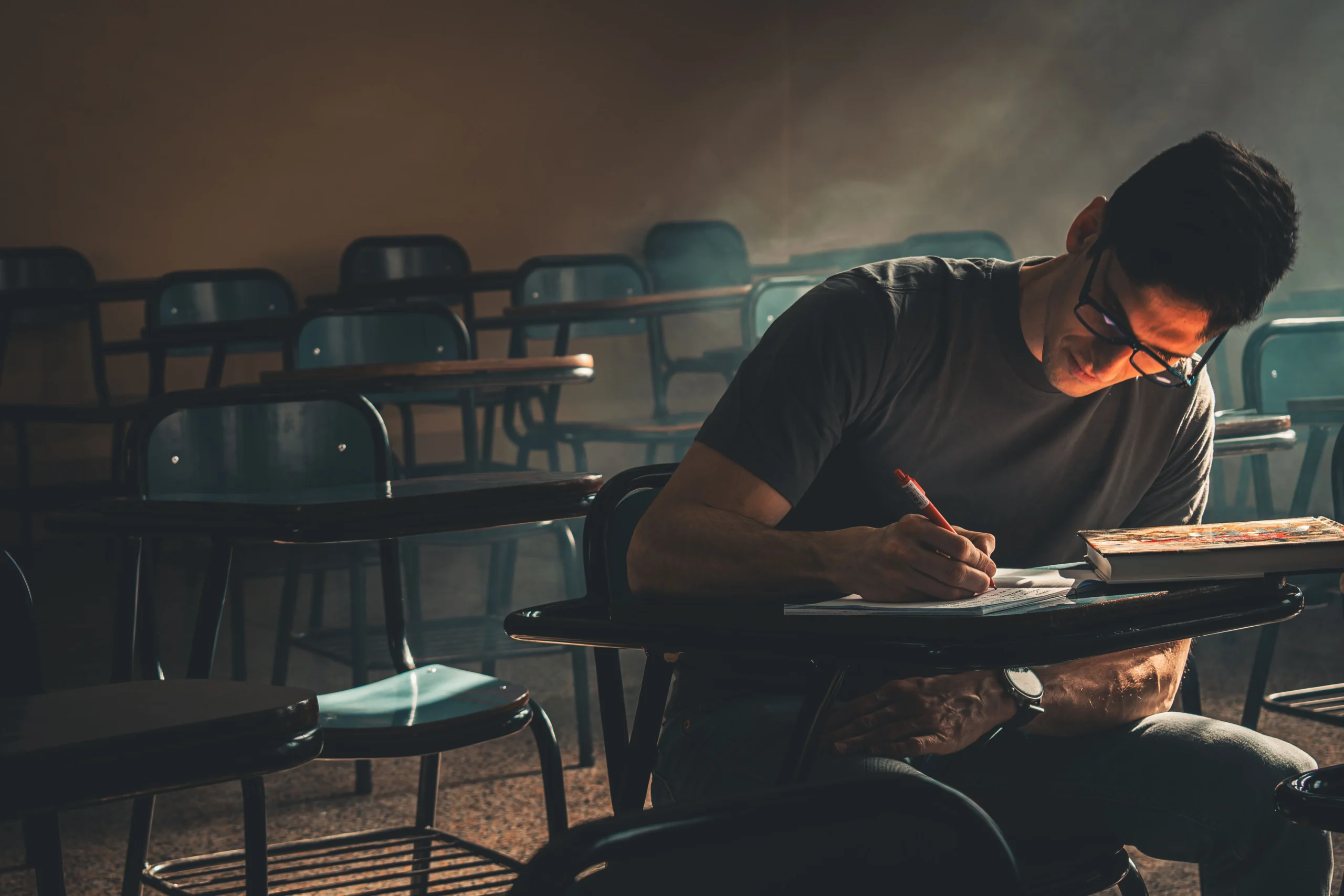 A man is sitting in the examination hall