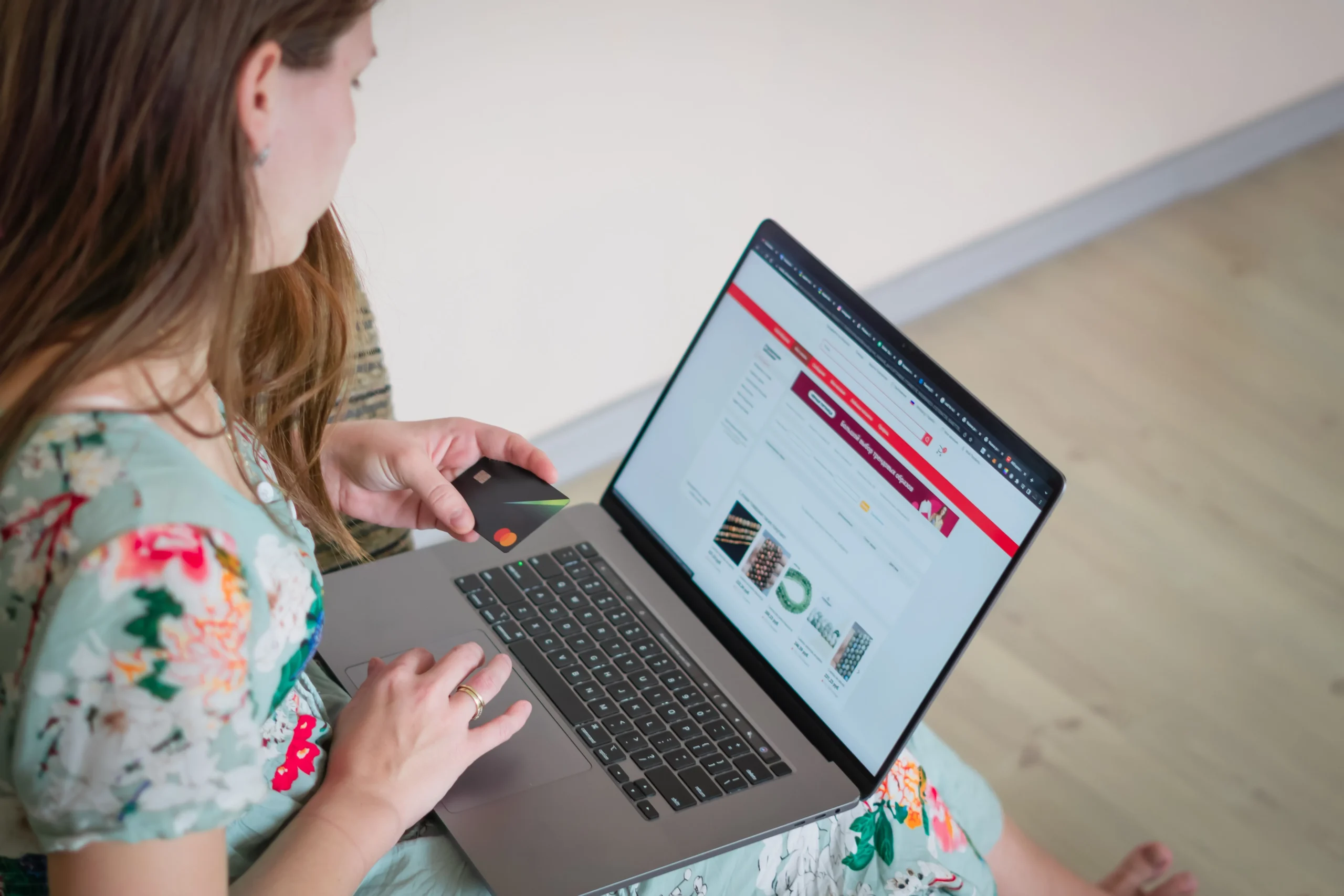 A young girl is working on the laptop.