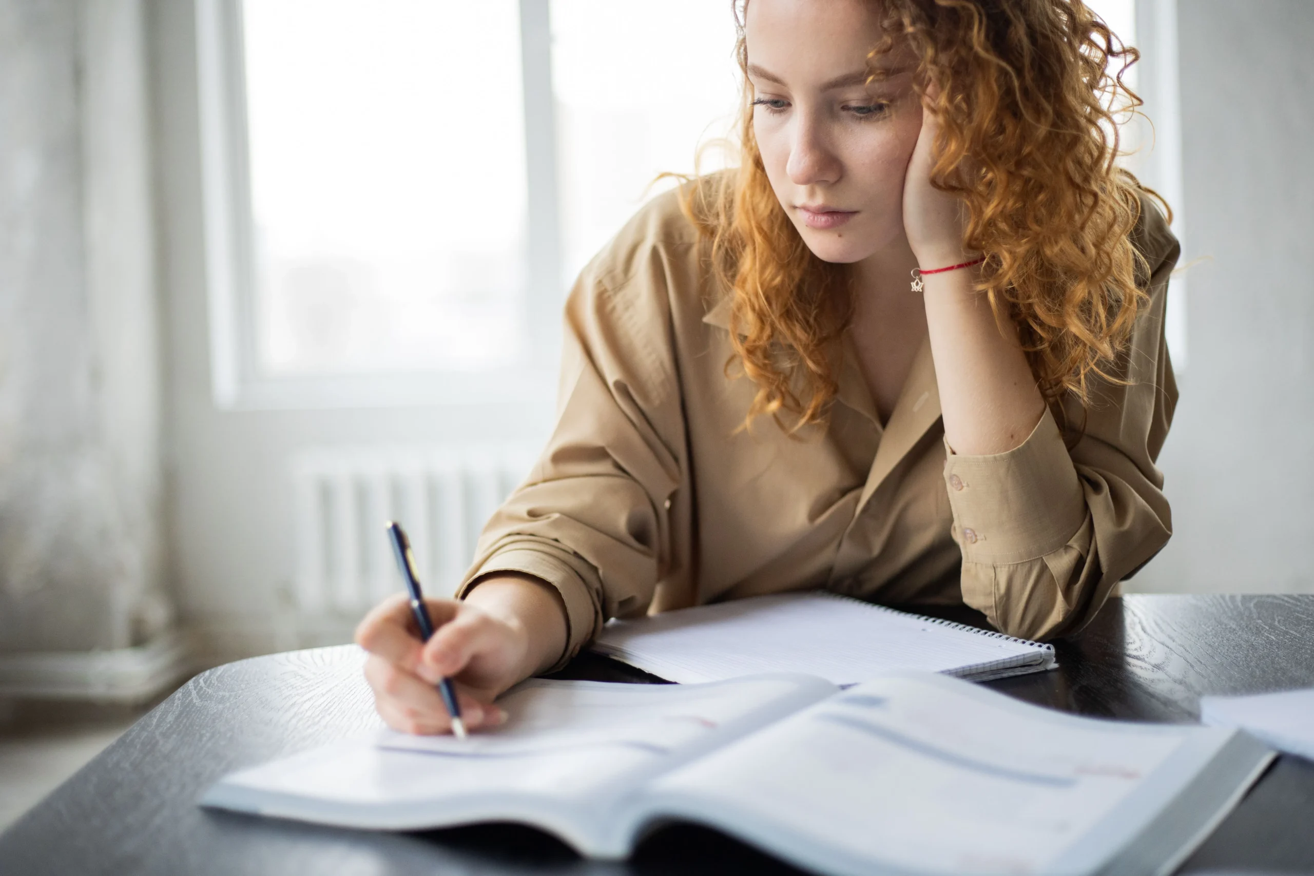 A young girl is studying